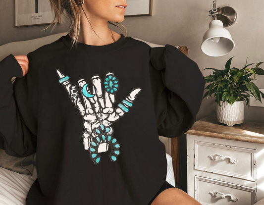 Turquoise Skeleton Rock Hand Graphic on Gildan Softstyle Black Shirt – Graphic Tee, Long Sleeve & Crewneck.